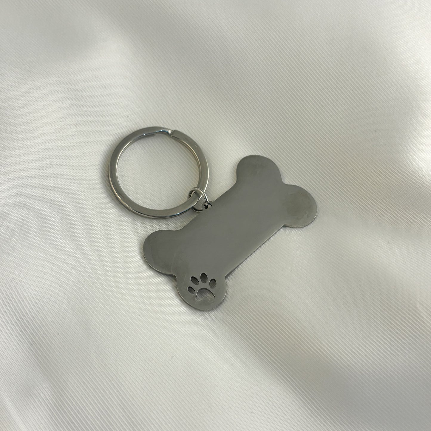 Llavero plaquita hueso acero inoxidable patita de perro