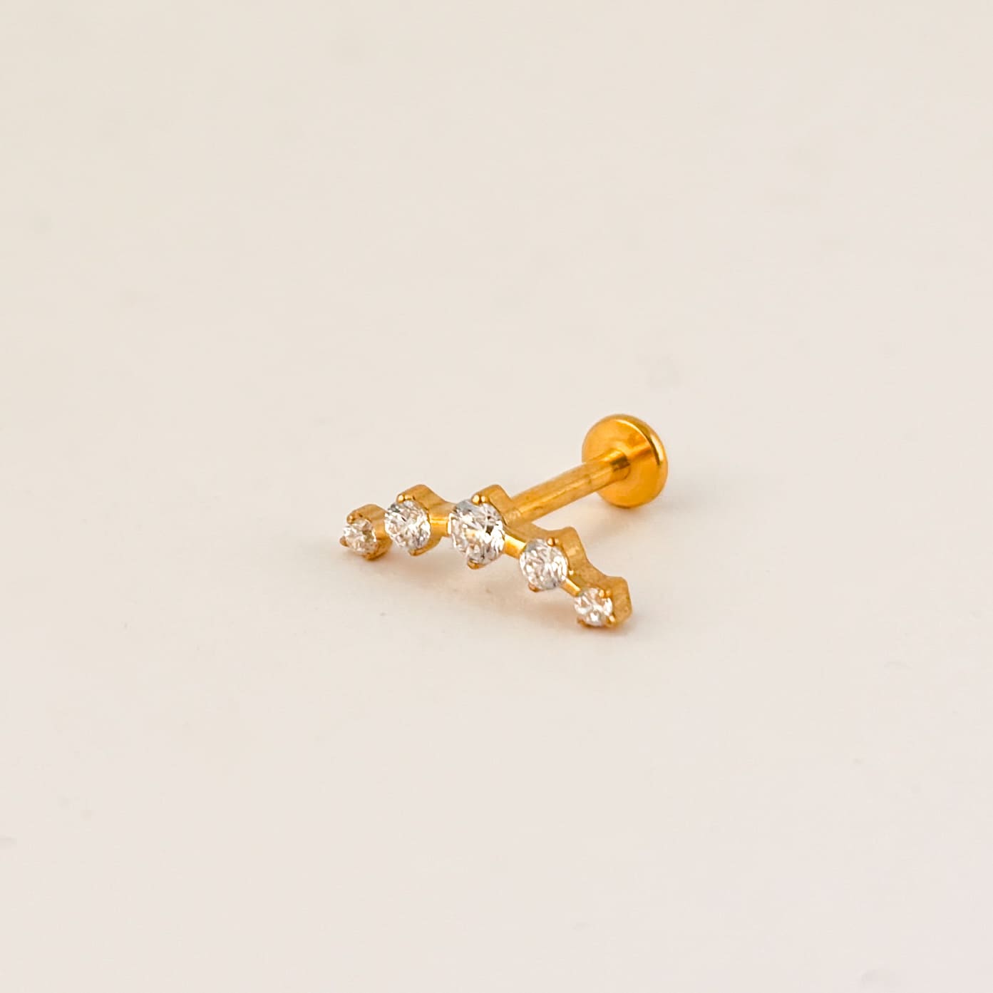 Piercing acero quirúrgico dorado curva 5 zirconias