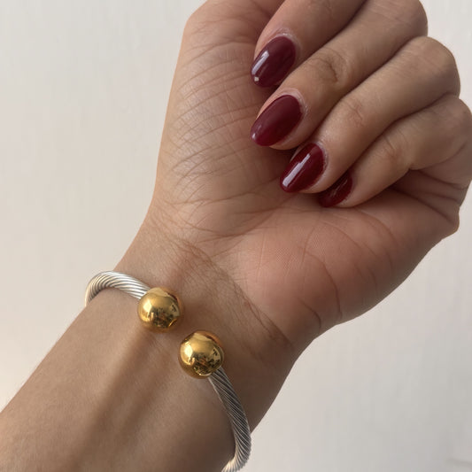 Brazalete acero inoxidable torcido esferas bicolor