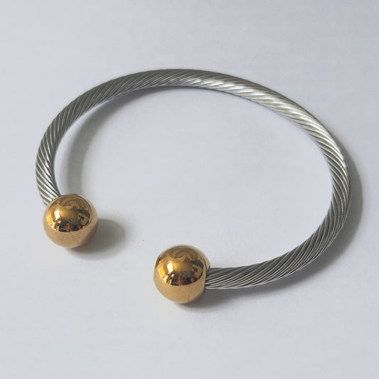 Brazalete acero inoxidable torcido esferas bicolor