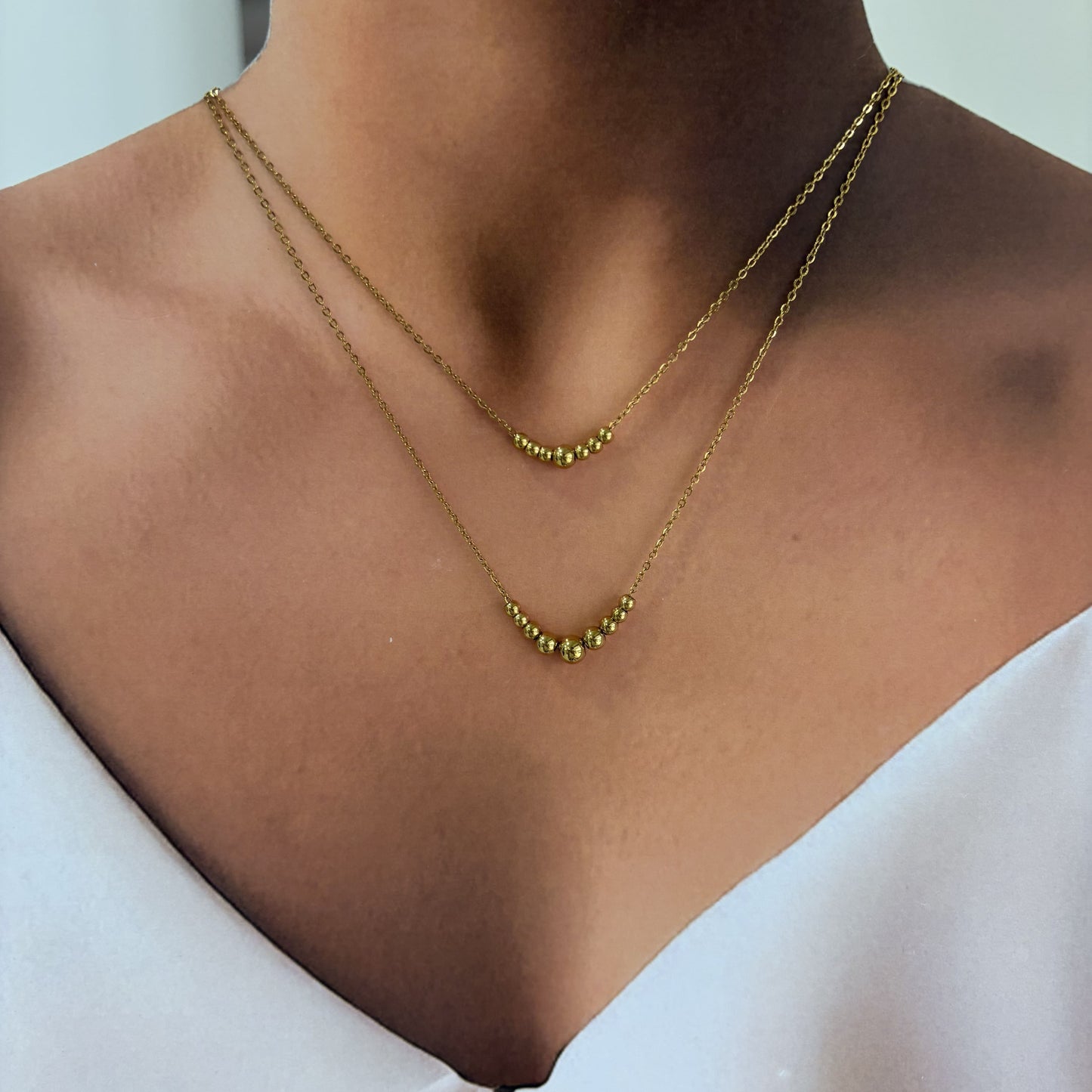 Collar acero inoxidable doble bolitas dorado