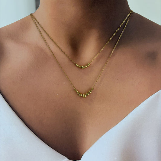 Collar acero inoxidable doble bolitas dorado