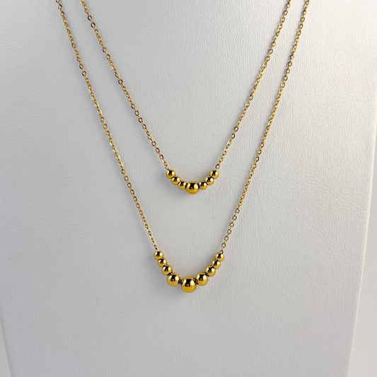 Collar acero inoxidable doble bolitas dorado