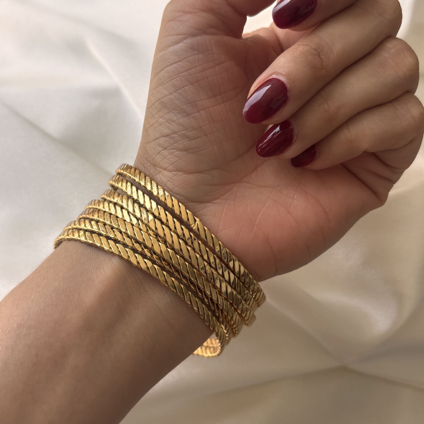 Semanario de brazaletes acero inoxidable trenzado dorado