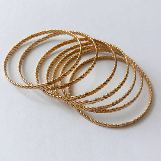 Semanario de brazaletes acero inoxidable trenzado dorado