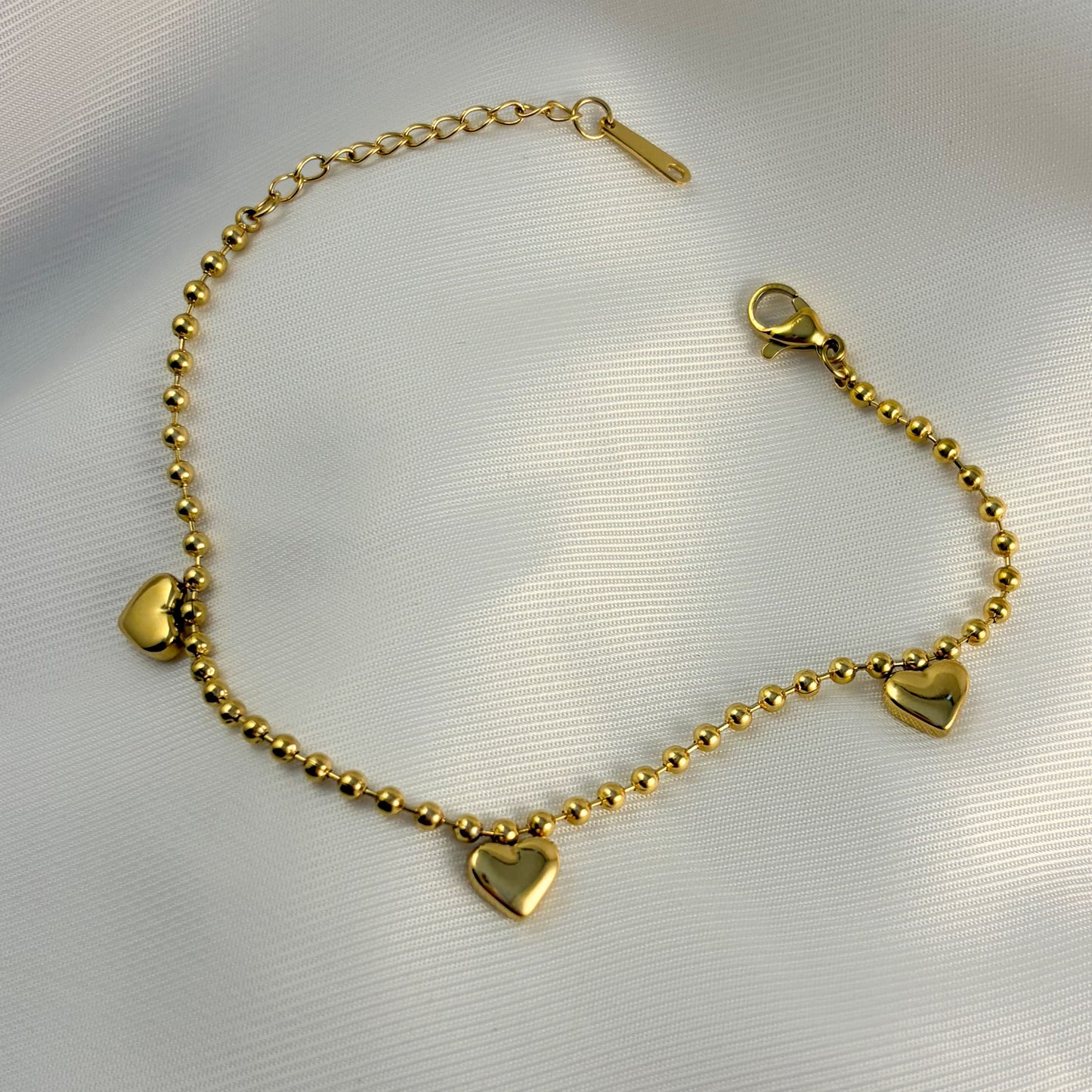 Pulsera acero inoxidable bolitas 3 corazones globo dorado