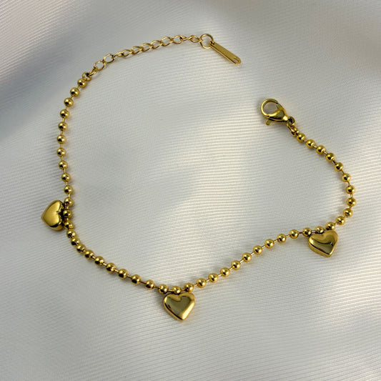 Pulsera acero inoxidable bolitas 3 corazones globo dorado