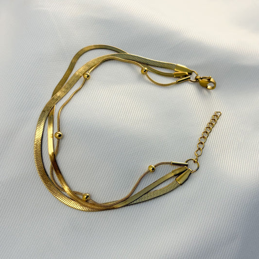 Pulsera triple acero inoxidable planchada bolitas dorado