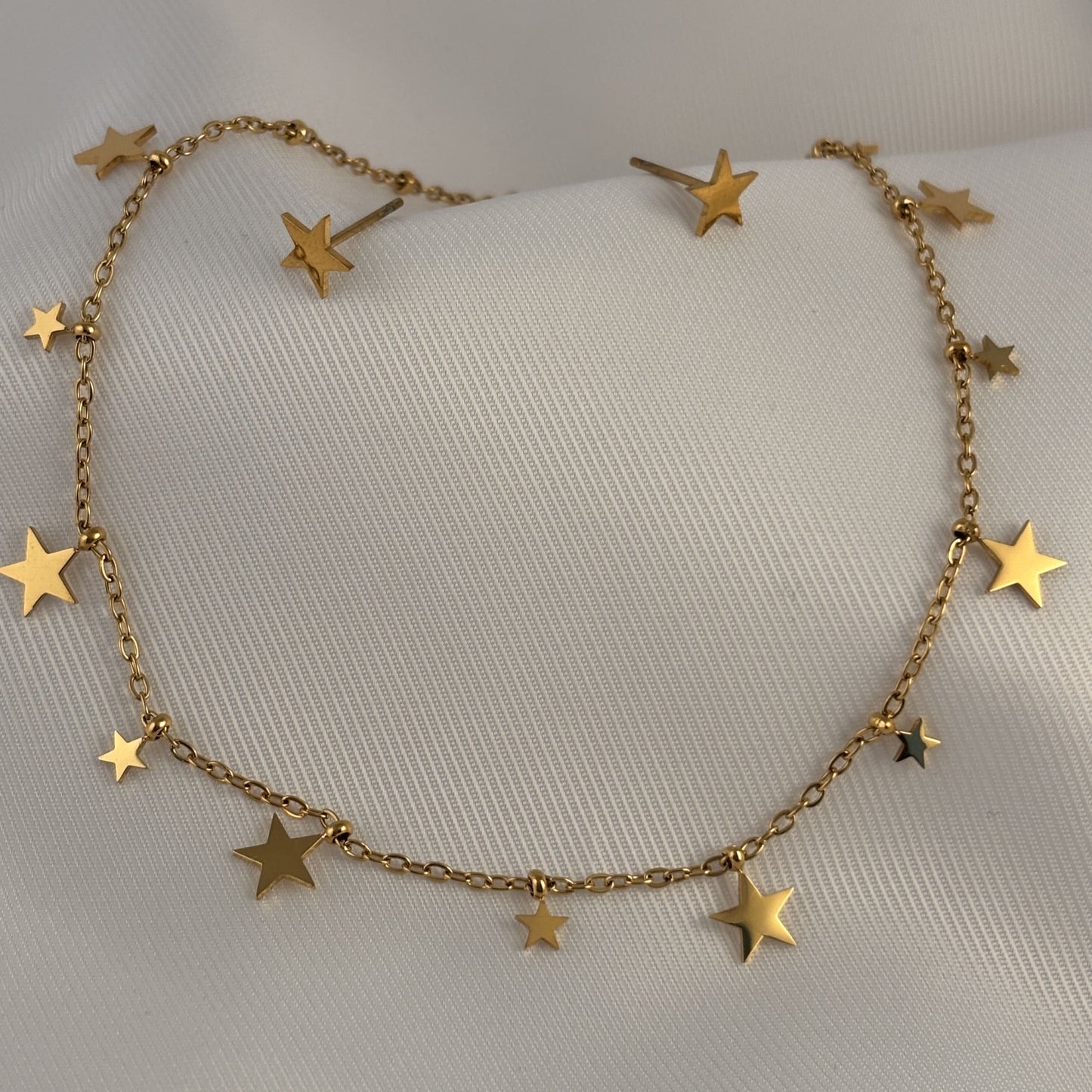 Set aretes y collar acero inoxidable estrellas chica y grande dorado
