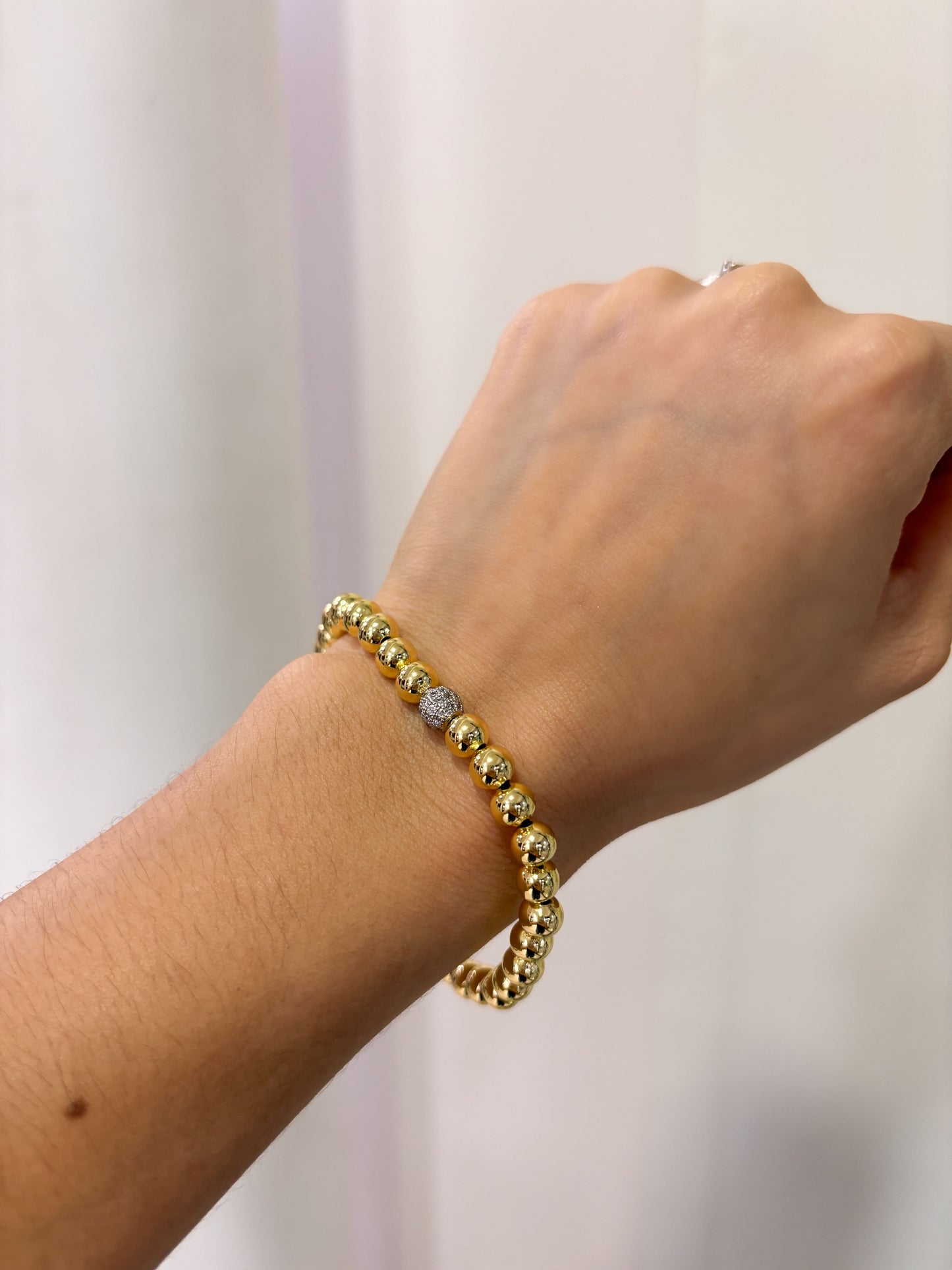 Pulsera bolitas eslástico esfera plateada zirconias chapa de oro