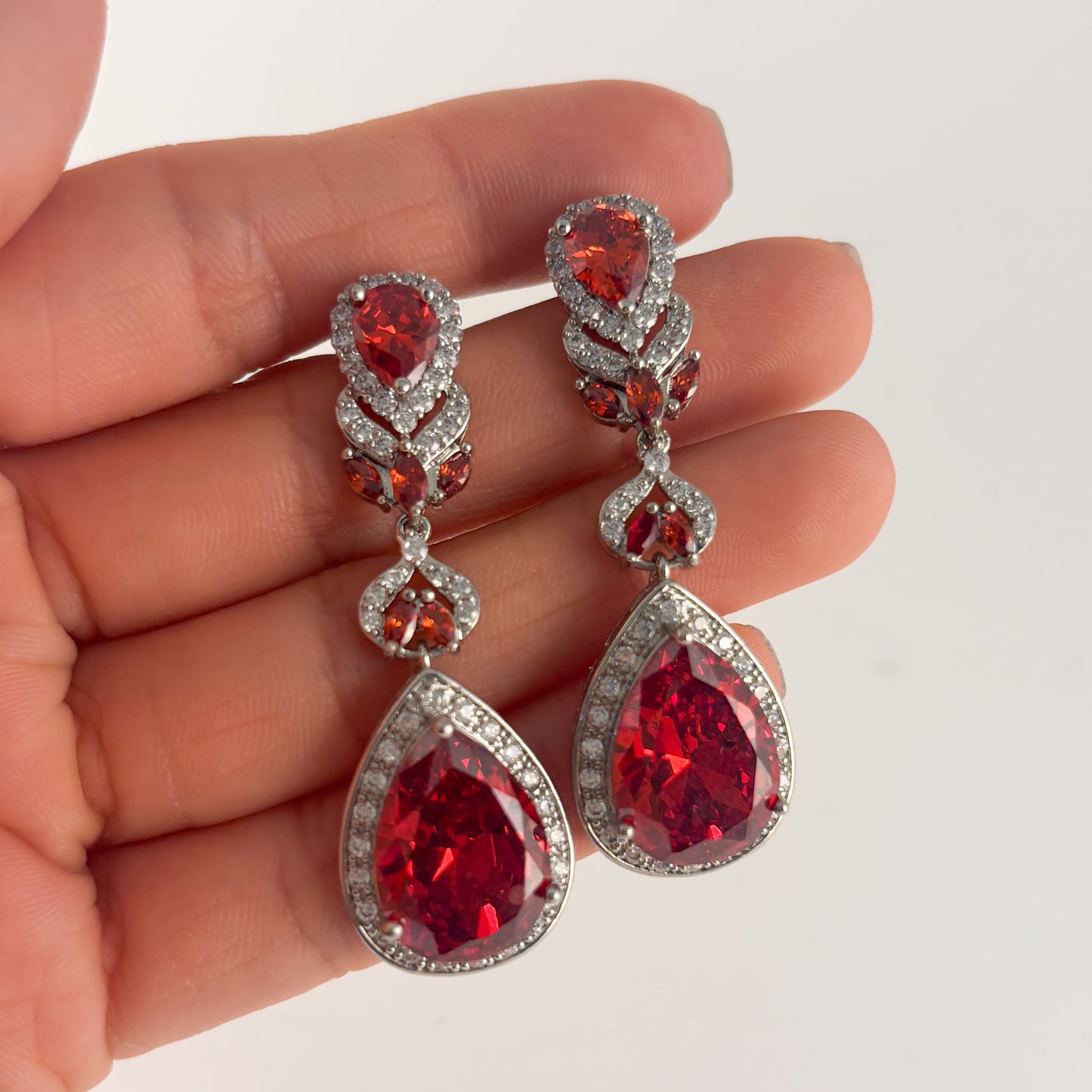 Aretes plateados elegantes zirconias rojas gota